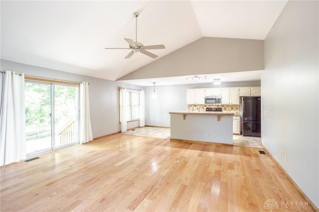 6437 Sun Ridge Dr, Waynesville, OH 45068 - unfurnished living room featuring ceiling fan, high vaulted ceiling, and light wood-type flooring