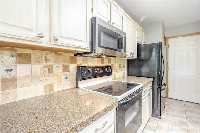 6437 Sun Ridge Dr, Waynesville, OH 45068 - kitchen with range with electric cooktop, stainless steel microwave, tasteful backsplash, light countertops, and white cabinets