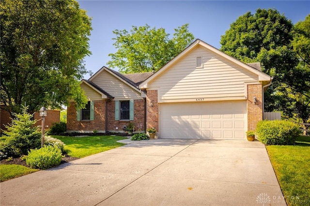 6437 Sun Ridge Dr, Waynesville, OH 45068 - ranch-style home featuring a garage, brick siding, driveway, and a front yard
