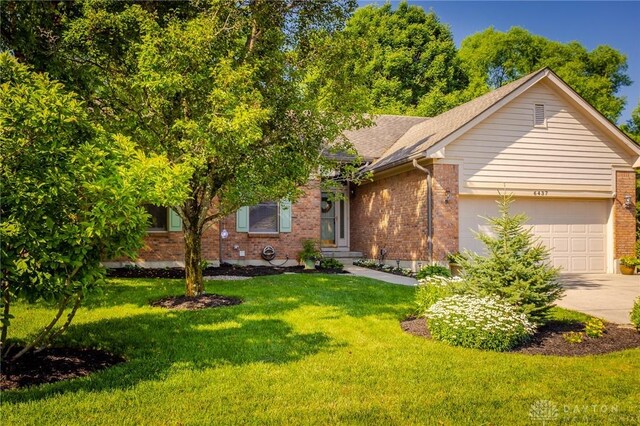 6437 Sun Ridge Dr, Waynesville, OH 45068 - view of front of house featuring a garage, brick siding, and concrete driveway