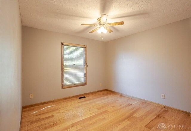6437 Sun Ridge Dr, Waynesville, OH 45068 - empty room featuring wood finished floors, a ceiling fan, and a textured ceiling