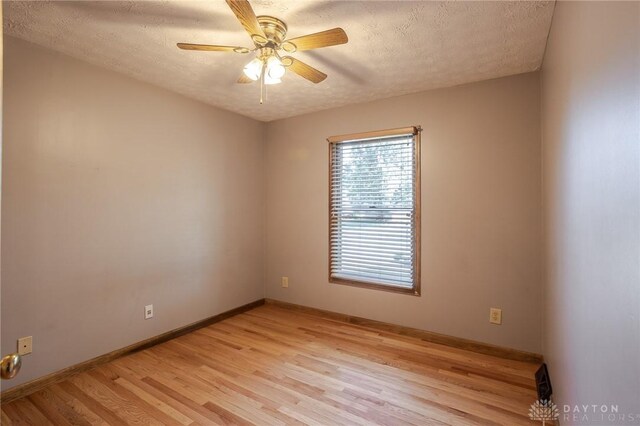 6437 Sun Ridge Dr, Waynesville, OH 45068 - empty room featuring light wood-style floors, a textured ceiling, and ceiling fan