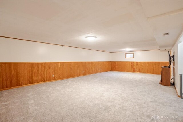 6437 Sun Ridge Dr, Waynesville, OH 45068 - carpeted empty room with wood walls and a wainscoted wall