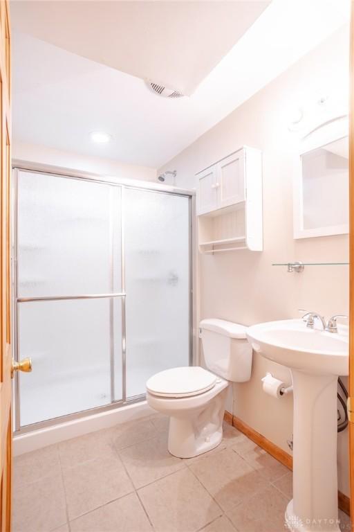 6437 Sun Ridge Dr, Waynesville, OH 45068 - bathroom with a stall shower and tile patterned floors