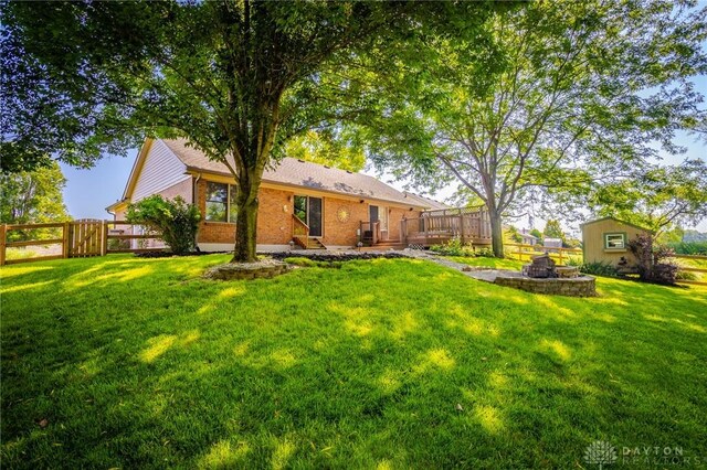 6437 Sun Ridge Dr, Waynesville, OH 45068 - back of property featuring a deck and brick siding