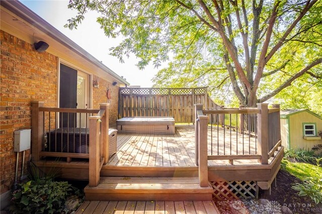 6437 Sun Ridge Dr, Waynesville, OH 45068 - wooden terrace featuring a covered hot tub and a shed