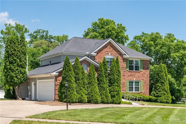 2384 Flyway Ct, Beavercreek, OH 45431 - view of front facade featuring brick siding, concrete driveway, a front yard, an attached garage, and roof with shingles