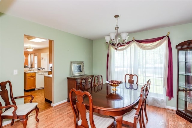 2384 Flyway Ct, Beavercreek, OH 45431 - dining area featuring a chandelier and light wood-style floors