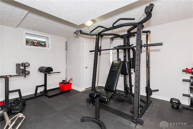 2384 Flyway Ct, Beavercreek, OH 45431 - exercise room featuring baseboards and a textured ceiling