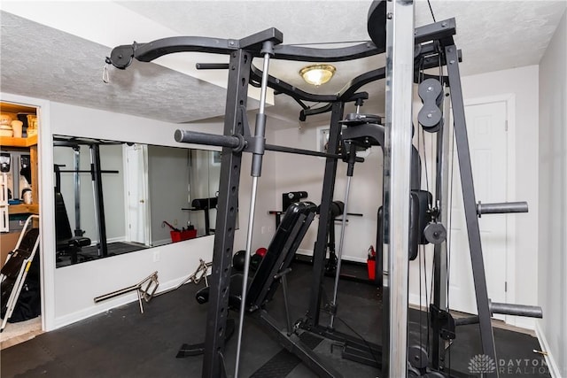 2384 Flyway Ct, Beavercreek, OH 45431 - exercise room featuring baseboards and a textured ceiling