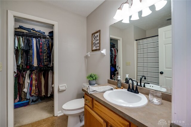 6426 Anvil Dr, Waynesville, OH 45068 - full bathroom featuring vanity, a walk in closet, a chandelier, and a shower with shower curtain