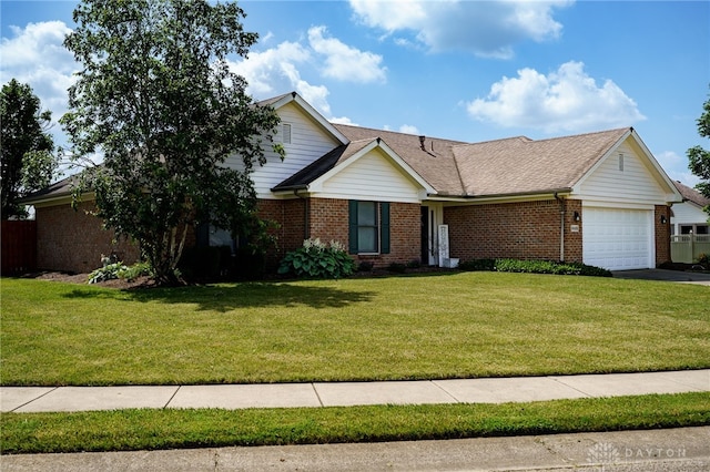 6426 Anvil Dr, Waynesville, OH 45068 - view of front of property featuring brick siding, an attached garage, a front lawn, and asphalt driveway