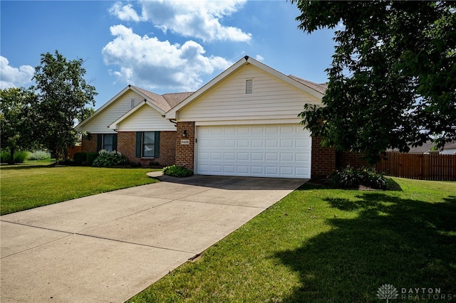 6426 Anvil Dr, Waynesville, OH 45068 - ranch-style house featuring a garage, brick siding, and concrete driveway