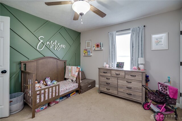 6426 Anvil Dr, Waynesville, OH 45068 - carpeted bedroom featuring a crib and ceiling fan
