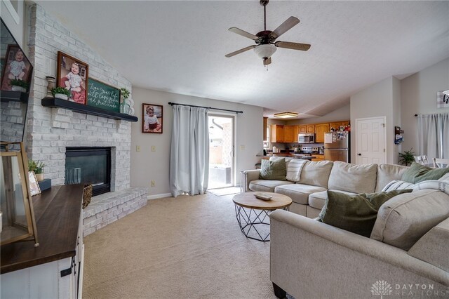 6426 Anvil Dr, Waynesville, OH 45068 - living room featuring a ceiling fan, lofted ceiling, light carpet, and a fireplace