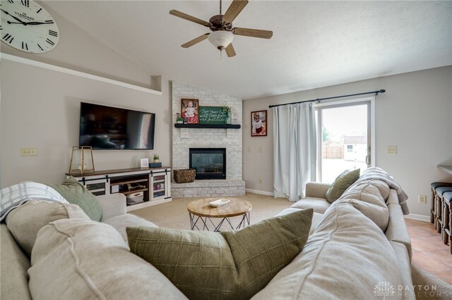 6426 Anvil Dr, Waynesville, OH 45068 - living area with a ceiling fan, lofted ceiling, a brick fireplace, and tile patterned floors