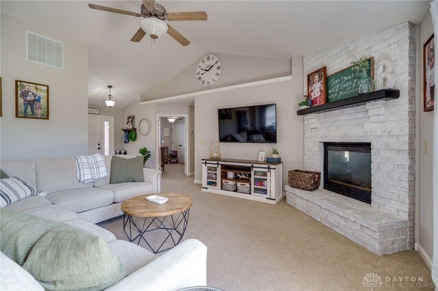 6426 Anvil Dr, Waynesville, OH 45068 - living area with carpet floors, a ceiling fan, a fireplace, and lofted ceiling