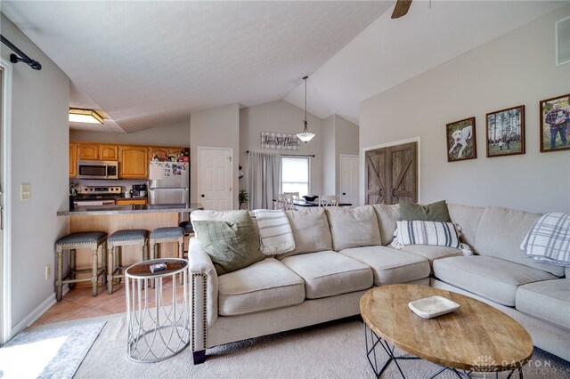 6426 Anvil Dr, Waynesville, OH 45068 - living area with vaulted ceiling and light tile patterned flooring
