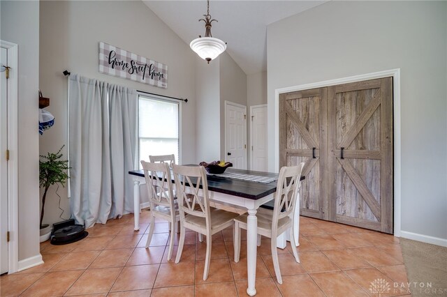 6426 Anvil Dr, Waynesville, OH 45068 - dining area with high vaulted ceiling and light tile patterned floors