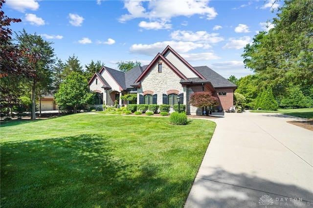7921 Locust Grove Ct, Springboro, OH 45066 - french country home featuring stone siding and a front yard