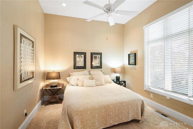 7921 Locust Grove Ct, Springboro, OH 45066 - carpeted bedroom featuring multiple windows and ceiling fan