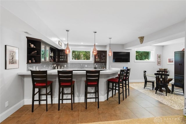 7921 Locust Grove Ct, Springboro, OH 45066 - indoor wet bar featuring decorative backsplash, light tile patterned flooring, pendant lighting, and recessed lighting