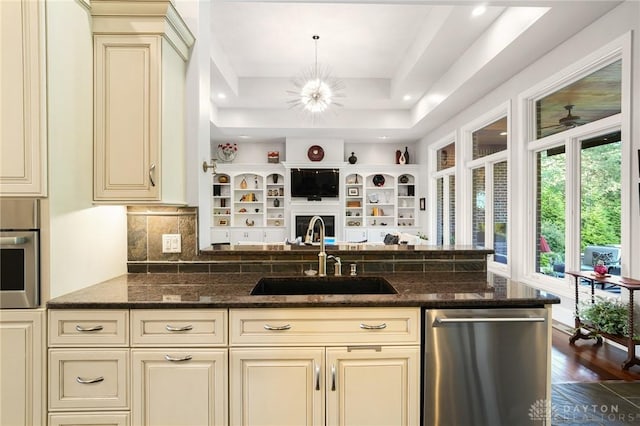 7921 Locust Grove Ct, Springboro, OH 45066 - kitchen featuring cream cabinets, appliances with stainless steel finishes, dark stone counters, open floor plan, and recessed lighting