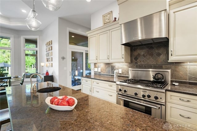 7921 Locust Grove Ct, Springboro, OH 45066 - kitchen featuring high end stainless steel range, wall chimney range hood, decorative backsplash, dark stone countertops, and recessed lighting