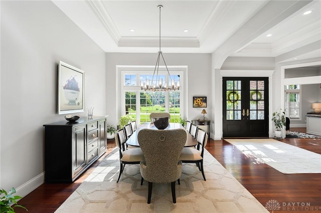 7921 Locust Grove Ct, Springboro, OH 45066 - dining area with a chandelier, a tray ceiling, wood finished floors, french doors, and crown molding