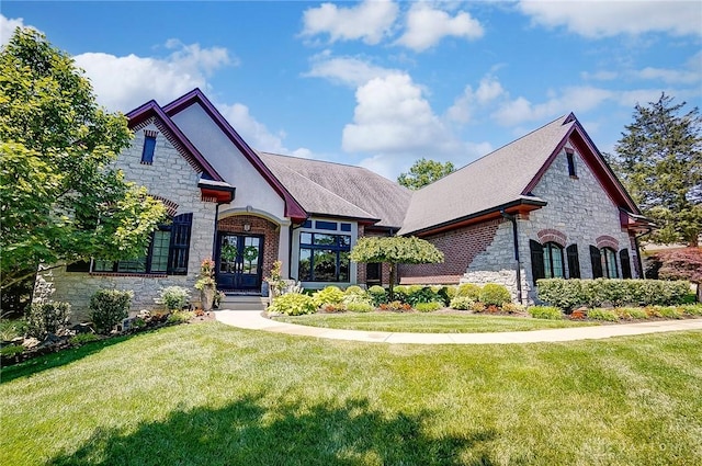 7921 Locust Grove Ct, Springboro, OH 45066 - french provincial home featuring stone siding, a front yard, and french doors