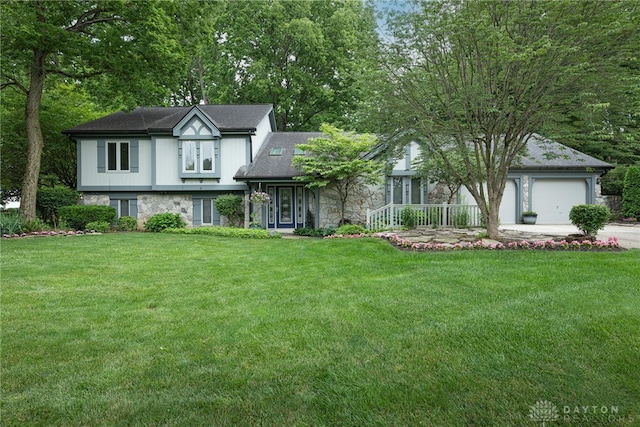 5010 Rhine Way, Centerville, OH 45458 - view of front of home with stone siding, concrete driveway, a front yard, and an attached garage