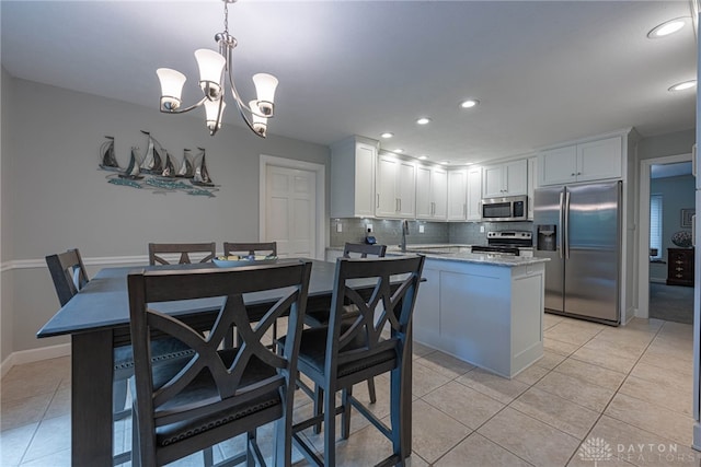 5010 Rhine Way, Centerville, OH 45458 - kitchen with appliances with stainless steel finishes, tasteful backsplash, recessed lighting, light tile patterned flooring, and white cabinetry