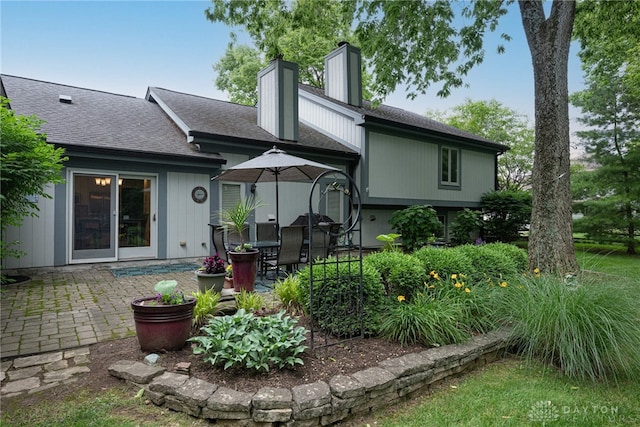 5010 Rhine Way, Centerville, OH 45458 - rear view of house with a patio, a chimney, and roof with shingles