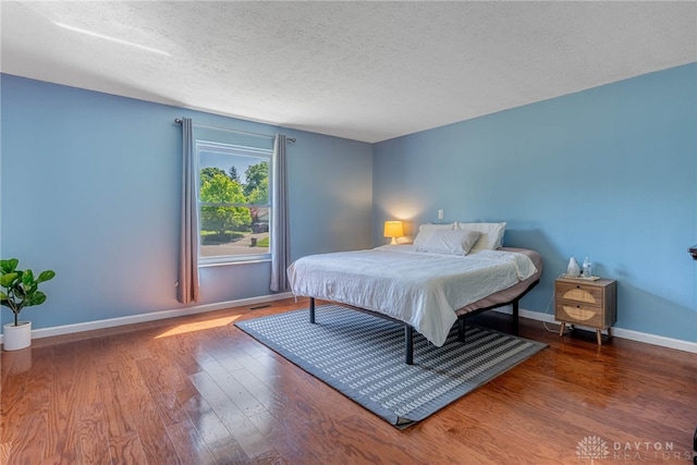 9031 S Normandy Ln, Washington Twp, OH 45458 - bedroom with a textured ceiling and wood finished floors