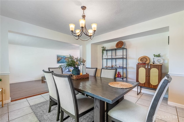 9031 S Normandy Ln, Washington Twp, OH 45458 - dining space with a chandelier, light tile patterned floors, and a textured ceiling