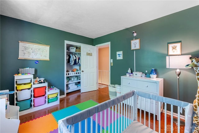 9031 S Normandy Ln, Washington Twp, OH 45458 - bedroom featuring wood finished floors and a crib