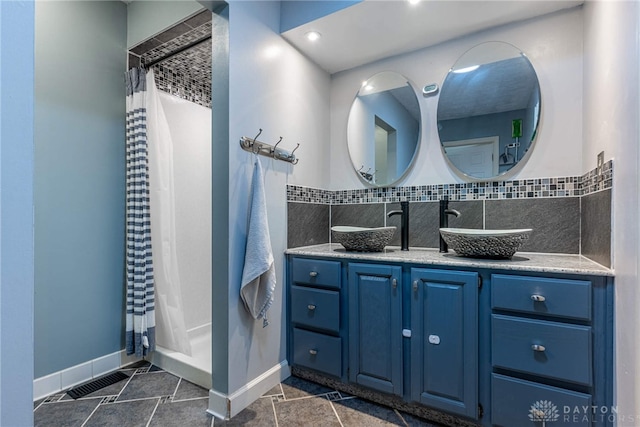 9031 S Normandy Ln, Washington Twp, OH 45458 - full bathroom featuring double vanity, a shower with shower curtain, and tasteful backsplash