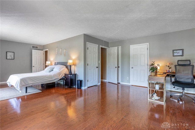 9031 S Normandy Ln, Washington Twp, OH 45458 - bedroom with wood finished floors, a desk, and a textured ceiling