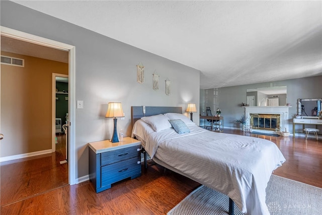 9031 S Normandy Ln, Washington Twp, OH 45458 - bedroom featuring wood finished floors and a glass covered fireplace