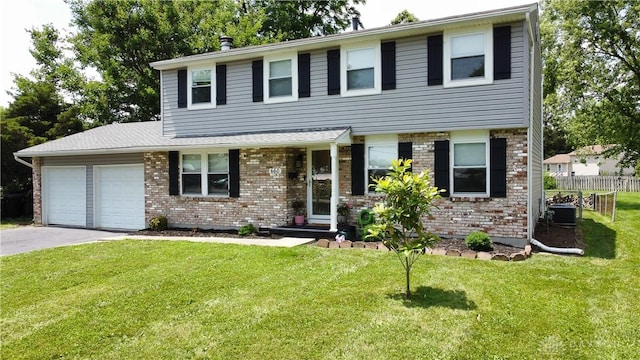 660 N Main St, Union, OH 45322 - view of front facade with an attached garage, asphalt driveway, and brick siding