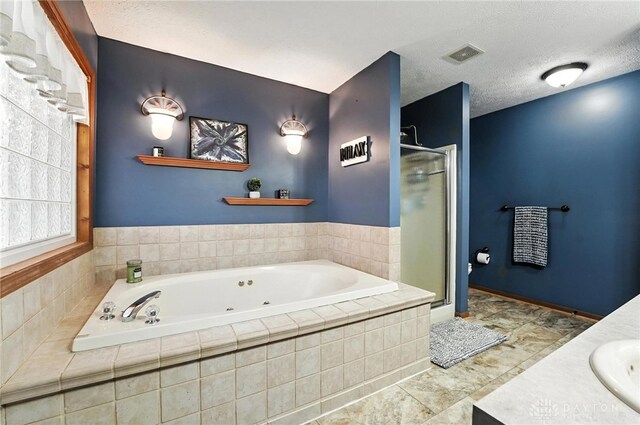 450 Overfield Pl, Troy, OH 45373 - bathroom with a stall shower, a tub with jets, vanity, and a textured ceiling