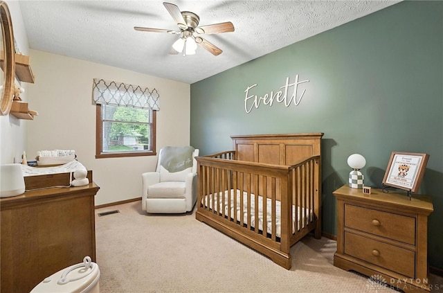 450 Overfield Pl, Troy, OH 45373 - carpeted bedroom featuring a nursery area, a ceiling fan, and a textured ceiling