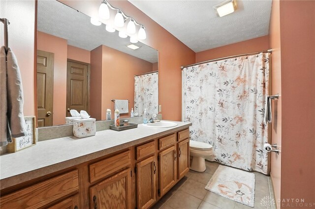 450 Overfield Pl, Troy, OH 45373 - bathroom featuring tile patterned flooring, vanity, a shower with curtain, and a textured ceiling