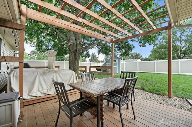 450 Overfield Pl, Troy, OH 45373 - wooden terrace with outdoor dining space, a storage unit, a fenced backyard, a pergola, and area for grilling