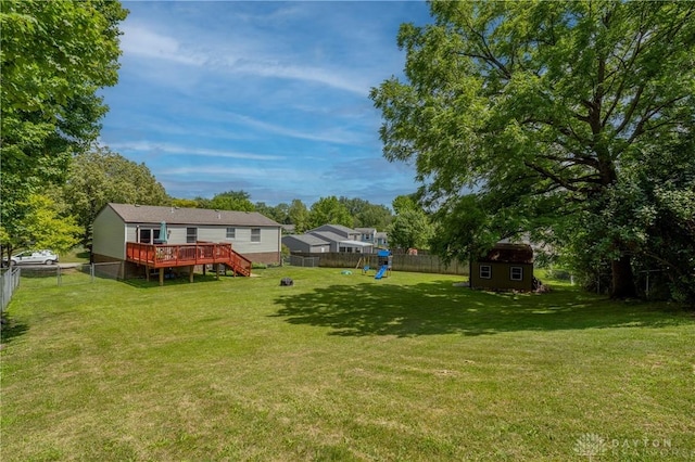 4913 Bittern Ct, Huber Heights, OH 45424 - fenced backyard with a playground, a storage unit, and a deck