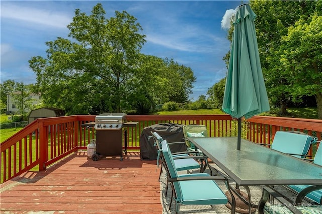 4913 Bittern Ct, Huber Heights, OH 45424 - wooden deck with outdoor dining area, area for grilling, and a storage shed
