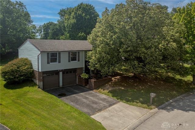 4913 Bittern Ct, Huber Heights, OH 45424 - view of front facade with driveway, a garage, brick siding, and a front lawn