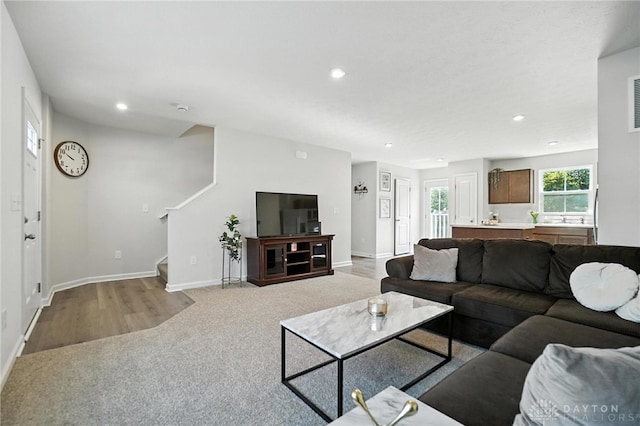 55 Spicewood Dr, Amelia, OH 45102 - living room featuring stairs, recessed lighting, light carpet, and light wood-style floors