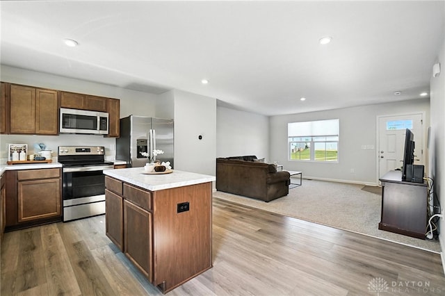 55 Spicewood Dr, Amelia, OH 45102 - kitchen featuring stainless steel appliances, a kitchen island, light countertops, light wood-style floors, and recessed lighting