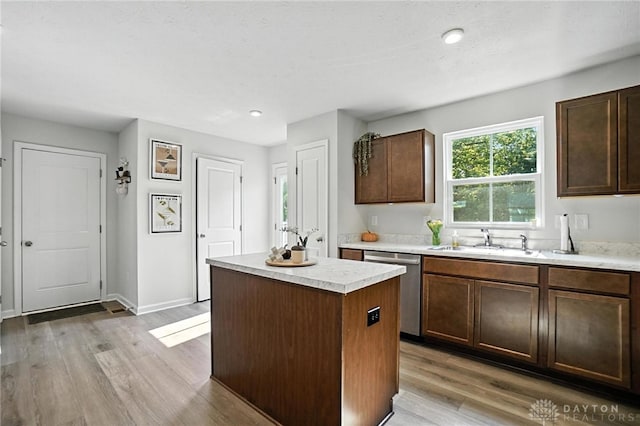 55 Spicewood Dr, Amelia, OH 45102 - kitchen with stainless steel dishwasher, a kitchen island, light countertops, light wood-style floors, and recessed lighting